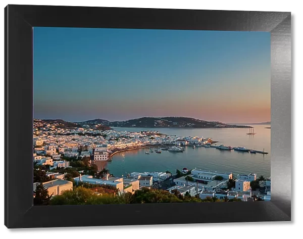 A scenic view of Chora and the nearby sea at sunset. Chora, Mykonos Island, Cyclades Islands, Greece