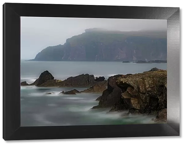 Ireland, Ferriter's Cove. Ocean and cliff in misty landscape