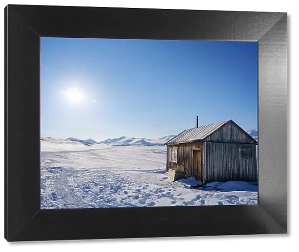 Traditional hut at frozen Gronfjorden, Island of Spitsbergen. Arctic region, Scandinavia, Norway, Svalbard