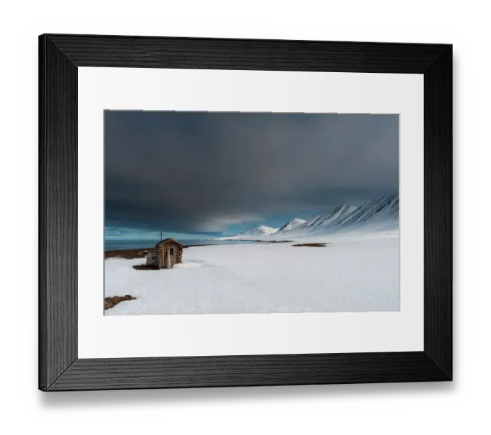 Framed Print : A fox hunting log cabin on the snow covered beach at Mushamna, Spitsbergen Island, Svalbard, Norway