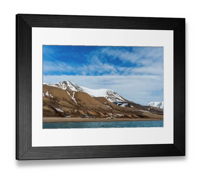 Framed Print : Snow streaked cliffs rise behind a small settlement near Longyearbyen on the bay of Adventfjorden. Spitsbergen Island, Svalbard, Norway Framed Print : Snow streaked cliffs rise behind a small settlement near Longyearbyen on the bay of Adventfjorden. Spitsbergen Island, Svalbard, Norway