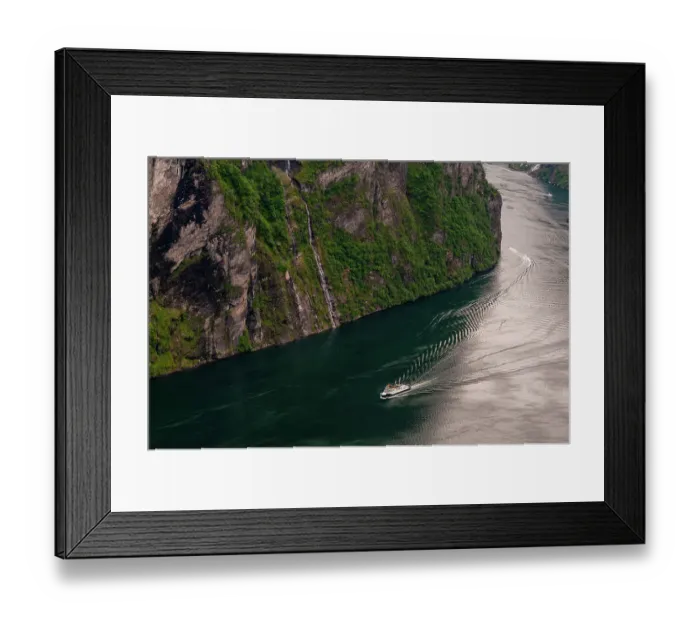 Framed Print : A cruise ship navigates past sheer cliffs in Geirangerfjord, Norway Framed Print : A cruise ship navigates past sheer cliffs in Geirangerfjord, Norway