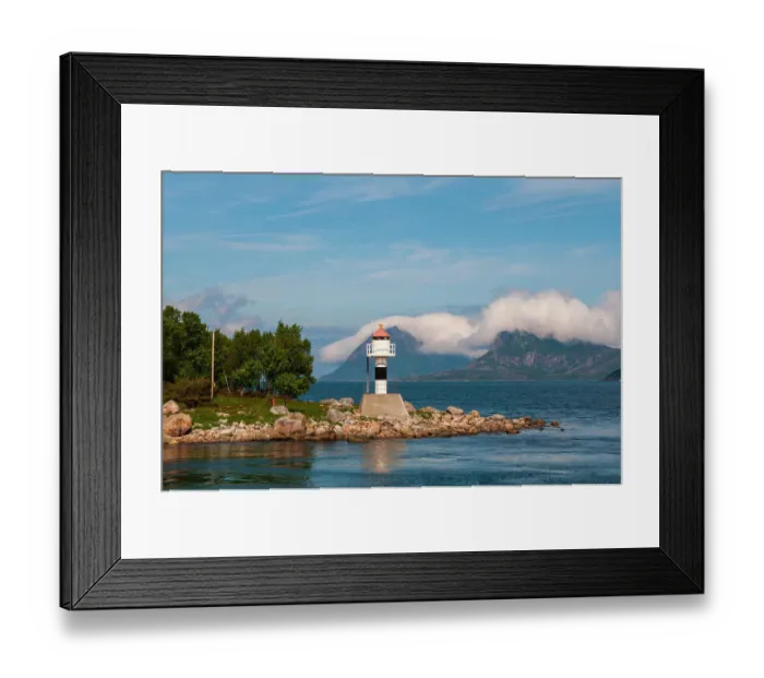 Framed Print : A lighthouse perches on a rocky promontory and reflects on Holandsfjorden. Svartisen, Norway Framed Print : A lighthouse perches on a rocky promontory and reflects on Holandsfjorden. Svartisen, Norway