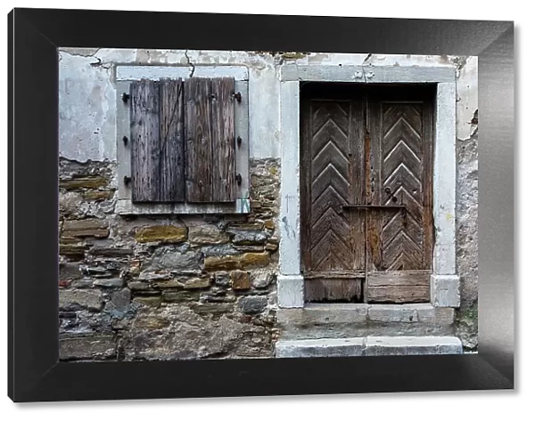 A view of a wooden door and shuttered window. Isola, Slovenia
