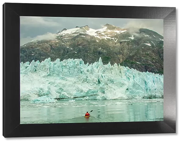 USA, Alaska, Glacier Bay National Park. Margerie Glacier ice and man in kayak