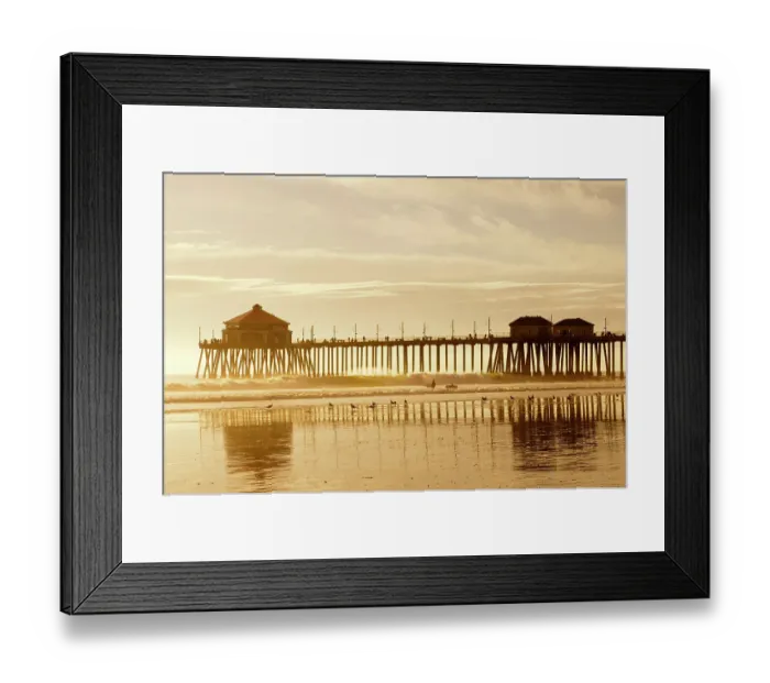 Framed Print : The Huntington Beach Pier and surfers at sunset. Huntington Beach, California Framed Print : The Huntington Beach Pier and surfers at sunset. Huntington Beach, California