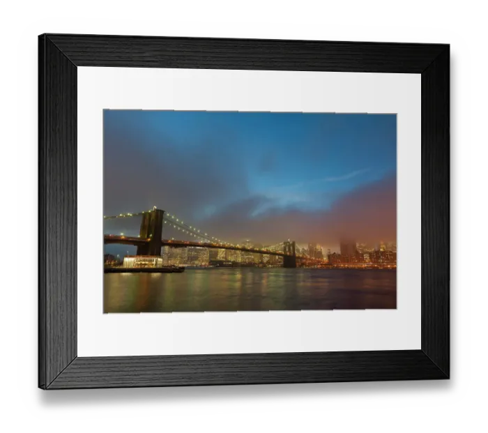 Framed Print : Manhattan skyline and the Brooklyn bridge in the mist at dusk