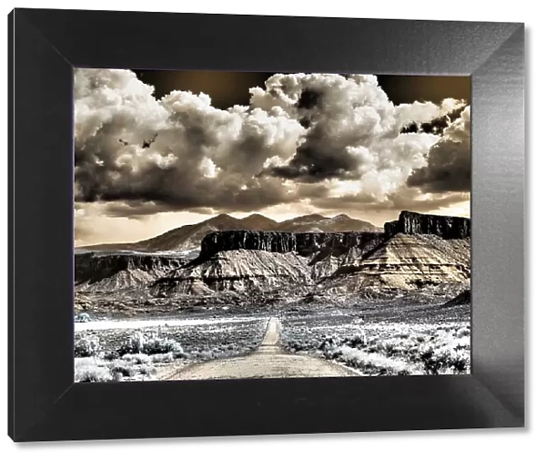 USA, Utah. Infrared of road leading to Fisher Tower and large clouds