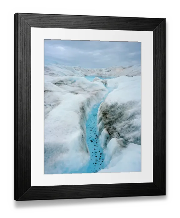 Framed Print : Drainage system on the surface of the ice sheet. The brown sediment on the ice is created by the rapid melting of the ice. Landscape of Greenland near Kangerlussuaq, Kingdom of Denmark