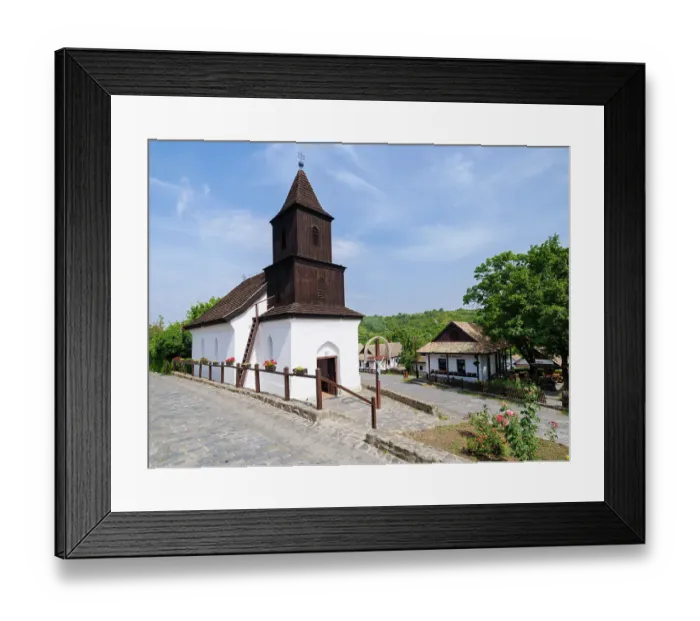 Framed Print : The church. The Paloc village Holloko in Hungary, listed as UNESCO World Heritage Site. The traditional farm houses form a complete village as it looked during the middle ages Framed Print : The church. The Paloc village Holloko in Hungary, listed as UNESCO World Heritage Site. The traditional farm houses form a complete village as it looked during the middle ages