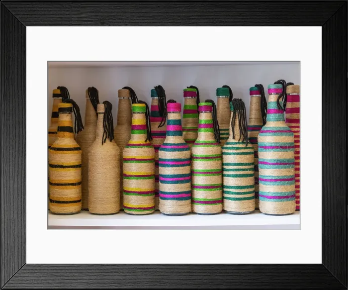 Framed Print : Yasmine Hammamet, Nabeul, Tunisia. Bottles decorated with colored string at a artisan crafts market in Tunisia