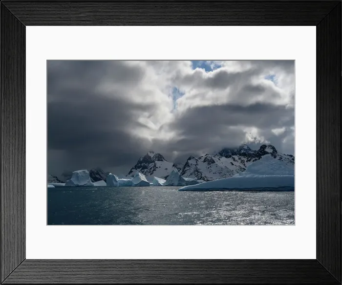 Framed Print : South Georgia Island. Sculpted blue icebergs floating in the Atlantic and mountain scenery