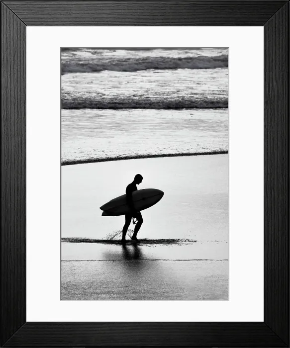 Framed Print : Lone surfer along the beach coming from the surf Framed Print : Lone surfer along the beach coming from the surf