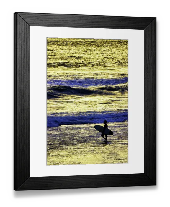 Framed Print : Lone surfer along the beach entering the surf