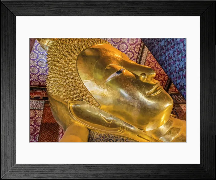 Framed Print : Colorful face Reclining Buddha, Wat Pho Temple, Bangkok, Thailand. Temple built in 1600's. Reclining Buddha built in 1832. Face reflects Buddha entry into heaven nirvana final goal of Buddhism