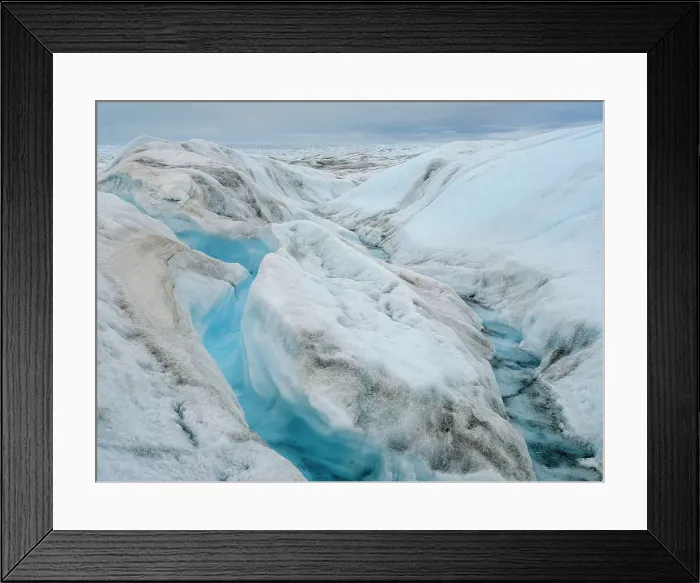 Framed Print : Drainage system on the surface of the ice sheet. The brown sediment on the ice is created by the rapid melting of the ice. Landscape of Greenland near Kangerlussuaq, Kingdom of Denmark