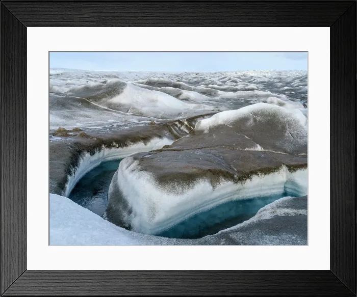 Framed Print : Drainage system on the surface of the ice sheet. The brown sediment on the ice is created by the rapid melting of the ice. Landscape of Greenland near Kangerlussuaq, Kingdom of Denmark