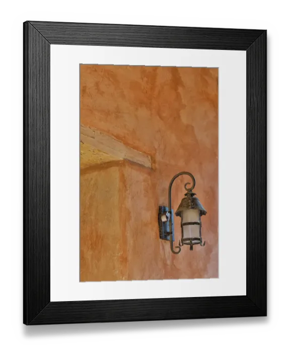 Framed Print : USA, California, Carmel. Inside the grounds at the Carmel Mission Basilica Museum old iron lamp on stucco wall