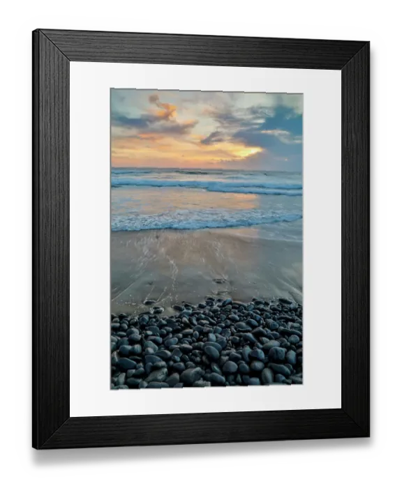 Framed Print : USA, Oregon, Arch Cape. Pacific coastline last evening light reflected in the sandy beach at low tide with foreground of shiny round black rocks