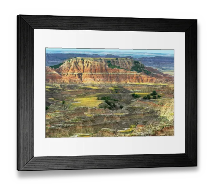Framed Print : The pink striped peaks or hoodoos are layered with grassy plateaus and valleys of green Framed Print : The pink striped peaks or hoodoos are layered with grassy plateaus and valleys of green