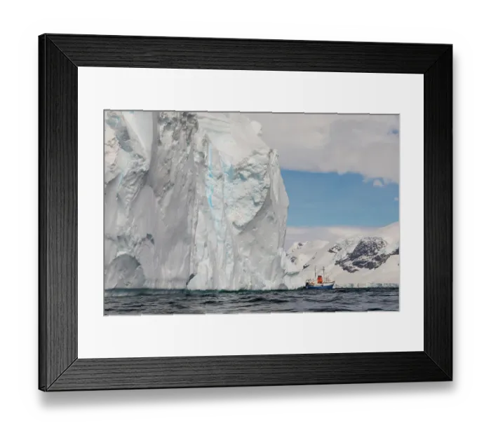 Framed Print : Southern Ocean, Antarctica. Huge weathered tabular icebergs appear to loom over a ship