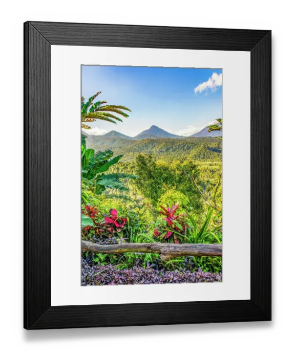 Framed Print : Bali, Indonesia. Vertical landscape view of lush tropical growth with three volcanos in the distance Framed Print : Bali, Indonesia. Vertical landscape view of lush tropical growth with three volcanos in the distance