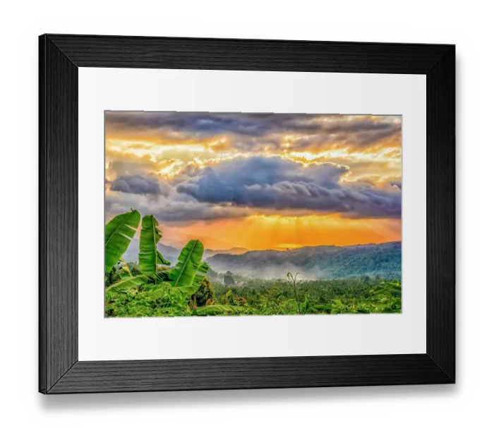 Framed Print : Coastal valley, Bali, Indonesia. Landscape view of sun breaking through clouds over a lush valley at sunset