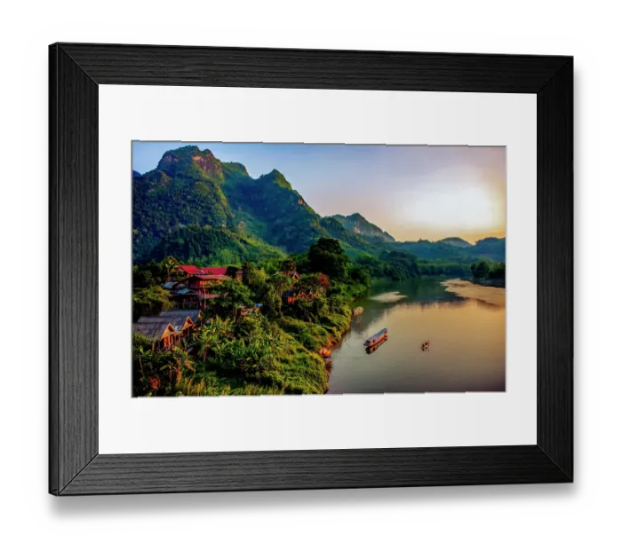 Framed Print : Mekong River village, Laos. Landscape view of mountain village at sunset lighting river and mountains