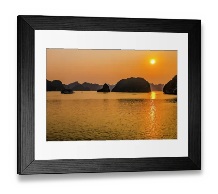 Framed Print : Ha Long Bay, Vietnam. Landscape view of boat carrying tourists at sunset through the limestone karsts and islets of the UNESCO Heritage Site Framed Print : Ha Long Bay, Vietnam. Landscape view of boat carrying tourists at sunset through the limestone karsts and islets of the UNESCO Heritage Site