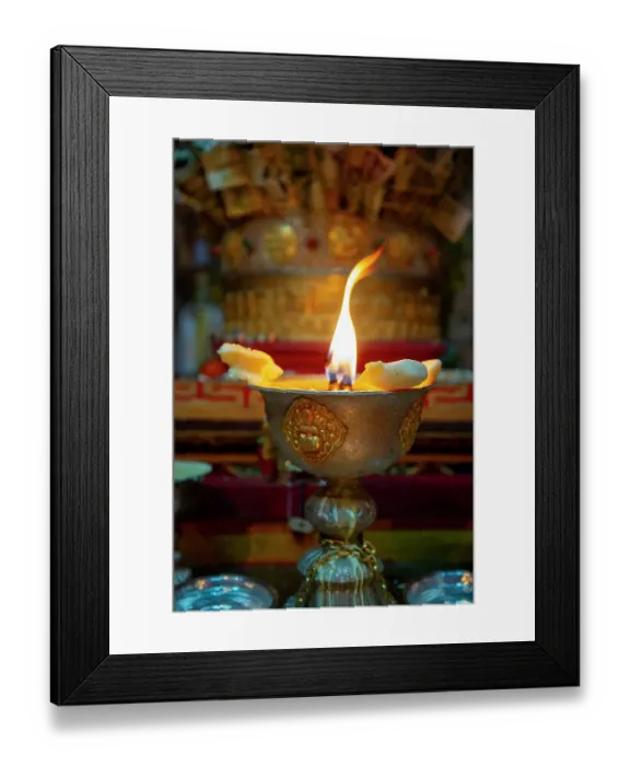 Framed Print : Tibet, Kham, Litang. A candle burns at the altar of a Litang Monastery