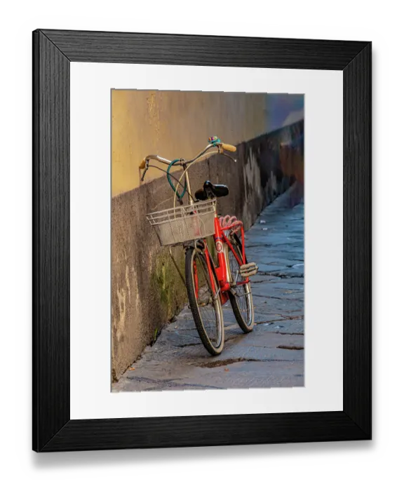Framed Print : Red bicycle leaning against a wall in an alley