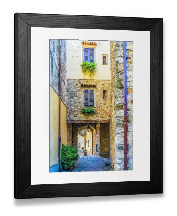 Framed Print : Greve in Chianti, Tuscany, Italy. Street view of ancient town showing colorful buildings with shuttered windows and stonework walls