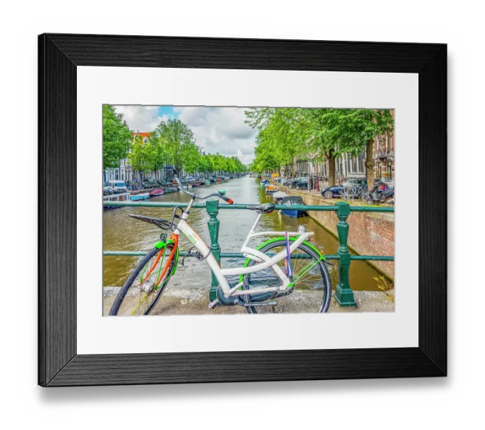 Framed Print : Amsterdam, Netherlands. Wide angle view of brightly painted bicycle locked to a bridge crossing the canal Framed Print : Amsterdam, Netherlands. Wide angle view of brightly painted bicycle locked to a bridge crossing the canal