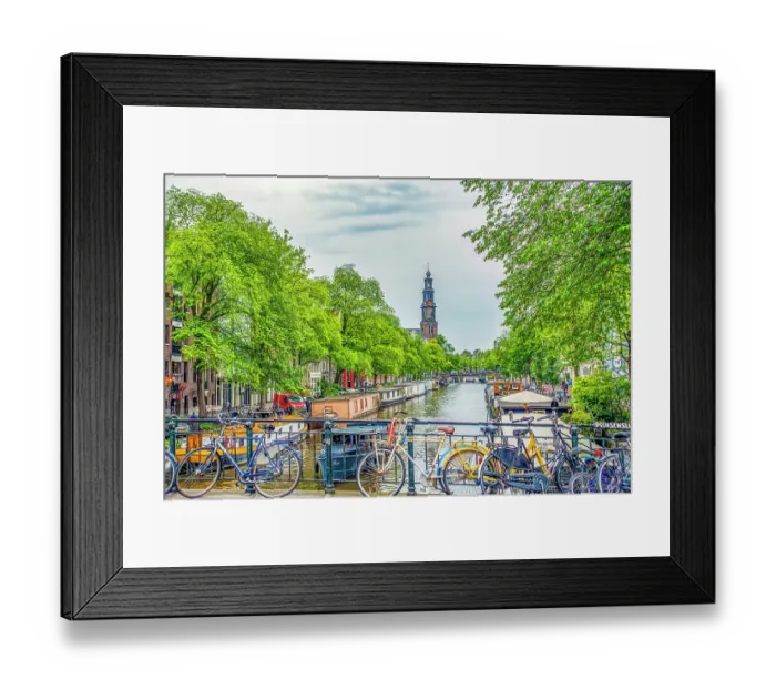Framed Print : Amsterdam, Netherlands. Wide angle view of Munttoren Tower at end of canal lined with boats and trees Framed Print : Amsterdam, Netherlands. Wide angle view of Munttoren Tower at end of canal lined with boats and trees