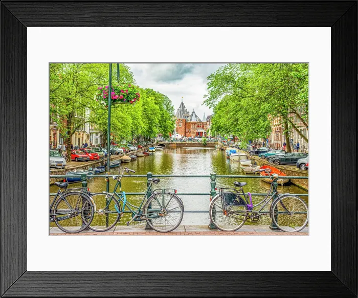 Framed Print : Amsterdam, Netherlands. Wide angle landscape view of bicycles chained to a bridge overlooking a canal