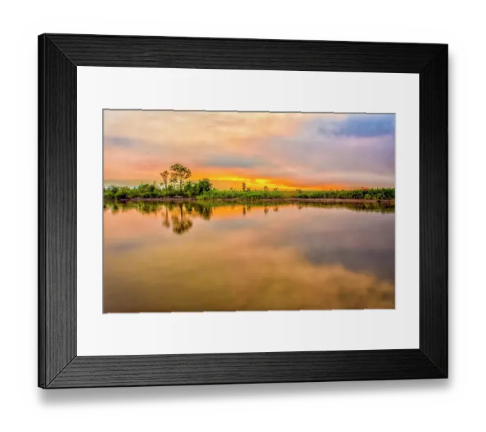 Framed Print : Sepik River, Papua New Guinea. Wide angle landscape view of jungle trees along sandy bank reflected in the river at sunset