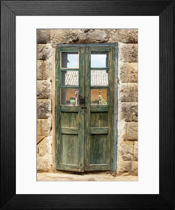 Framed Print : Old wooden door with worn out green paint nestles between walls built by the Inca in the 1440's in Ecuador. (Editorial Use Only)