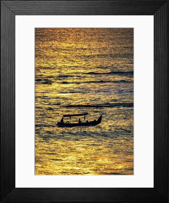Framed Print : Fishing boat returning to shore in a blaze of gold sunset light in Bali, Indonesia Framed Print : Fishing boat returning to shore in a blaze of gold sunset light in Bali, Indonesia