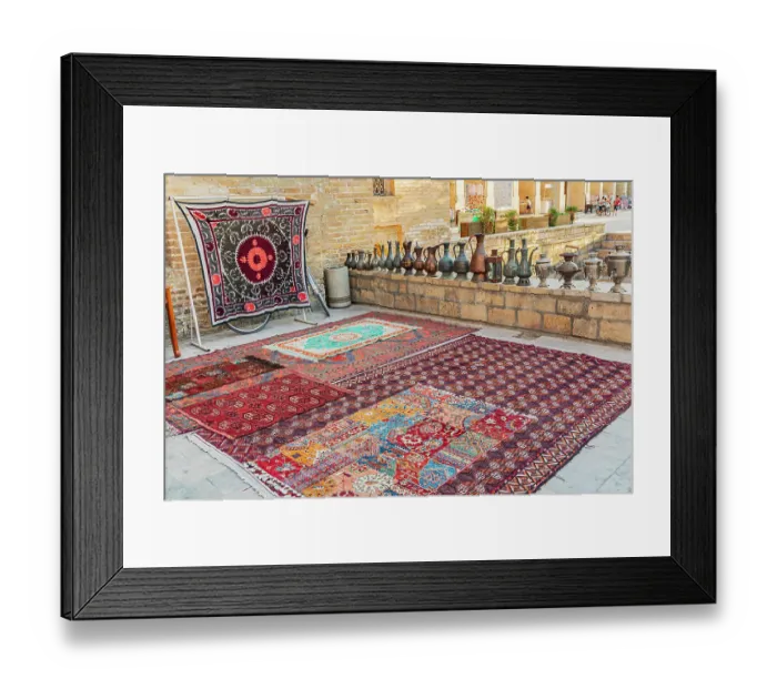 Framed Print : Bukhara, Uzbekistan, Central Asia. August 24, 2021. Rugs and traditional metal ware displayed for sale in Bukhara. Editorial Use Only