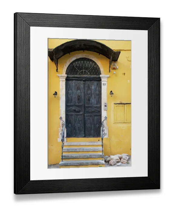 Framed Print : Greece, Crete, Chania, Old Town. Black double doorway in yellow wall