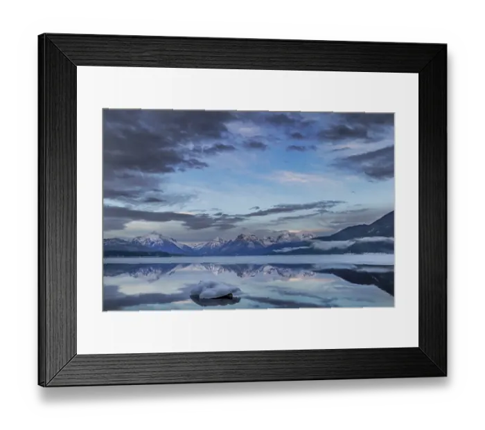 Framed Print : Clouds reflect in opening in the ice on Lake McDonald in Glacier National Park, Montana, USA. (Editorial Use Only)
