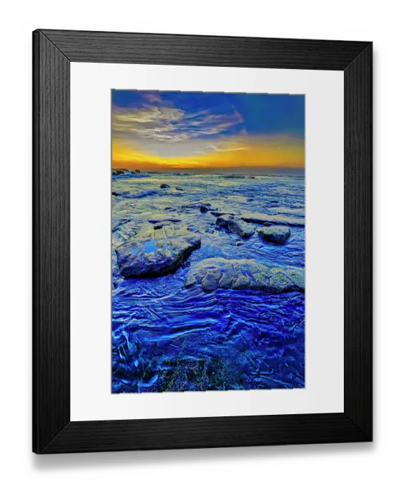 Framed Print : As the sun dips lower on the horizon, its warm, golden light can be absorbed and reflected by the black sand, intensifying the colors and creating a rich, deep contrast