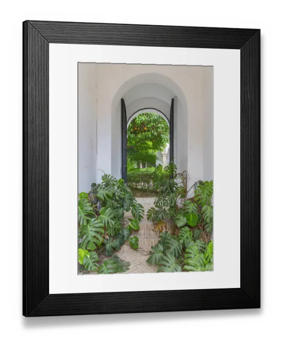 Framed Print : Casco Antiguo, Seville, Seville Province, Andalusia, Spain. May 5, 2023. Window to a garden at the Alcazar of Seville, a former Moorish citadel. Editorial Use Only