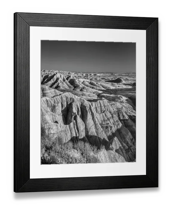 Framed Print : The wind and water eroded landscape in the Badlands National Park seem desolate but make for beautiful natural carvings. USA Framed Print : The wind and water eroded landscape in the Badlands National Park seem desolate but make for beautiful natural carvings. USA