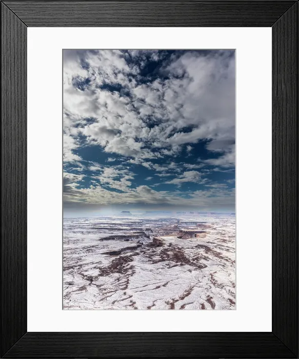 Framed Print : A light snowfall and contrasting orange-colored terrain define the rugged landscape of Canyonlands National Park