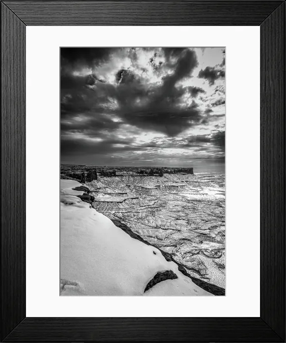 Framed Print : A light snowfall and contrasting darker terrain define the rugged landscape of Canyonlands National Park Framed Print : A light snowfall and contrasting darker terrain define the rugged landscape of Canyonlands National Park