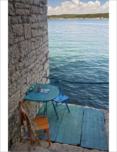 Oceanside seating for two at tiny outdoor cafe, Rovigno, Croatia