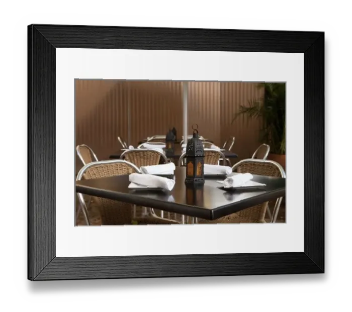 Framed Print : San Juan, Puerto Rico - A lamp is sitting on a restaurant table unlit. Surrounding