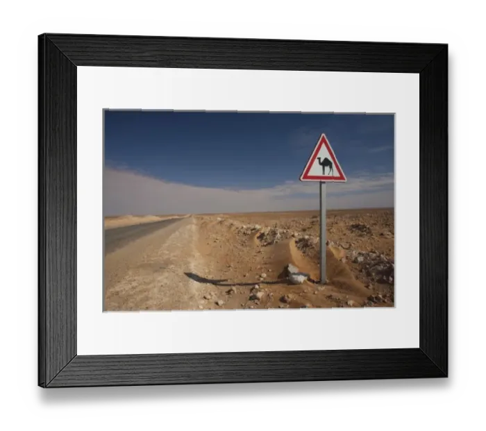 Framed Print : Tunisia, Ksour Area, Ksar Ghilane, Oil Pipeline road with camel crossing sign