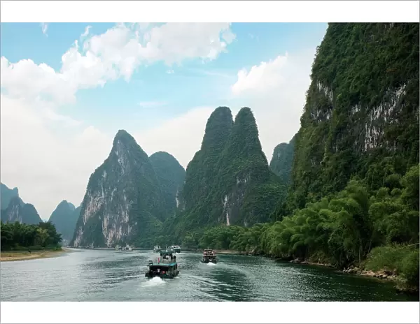 China, Guilin, Li River, River boats line the way along the River with its dramatic mountains